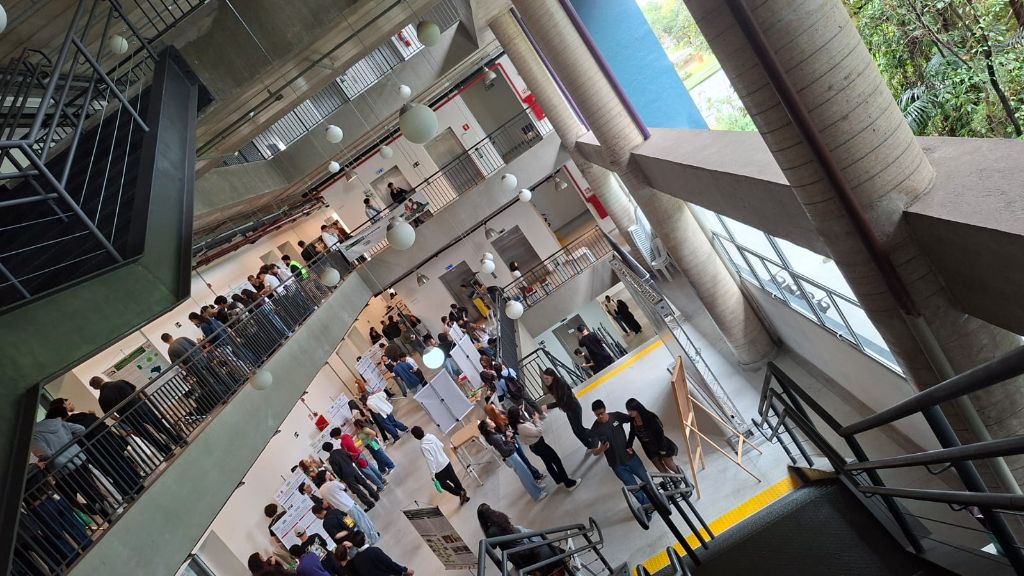 Vista do átrio do campus com estudantes e estandes de projetos na III edição, em 2026